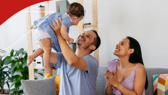 Familia de tres sonriendo sentados en un sillón